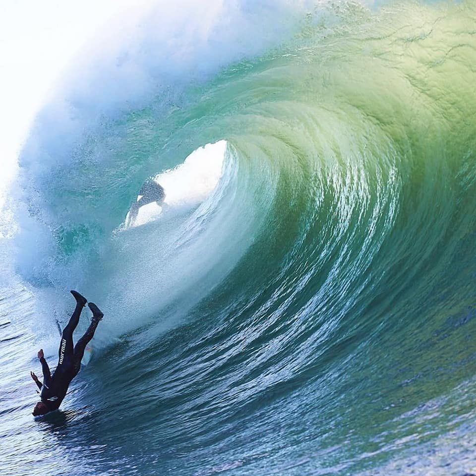 Headstand in the barrel of the wave